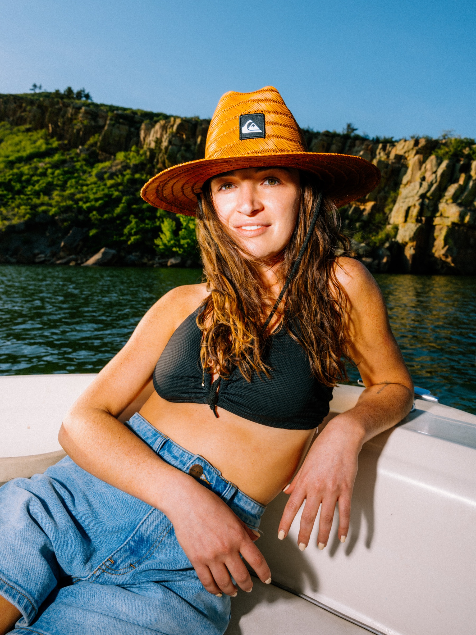 Woman smiling in Quiksilver straw hat, warm canyon light